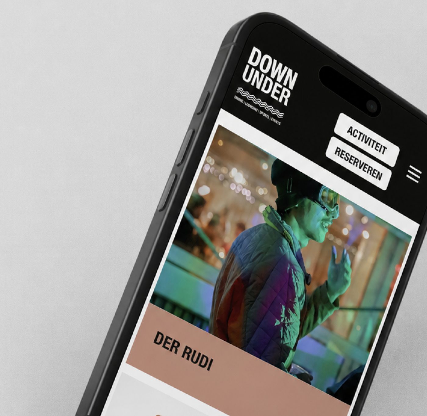 A phone mockup of the Down Under website, showing the Der Rudi nightlife section